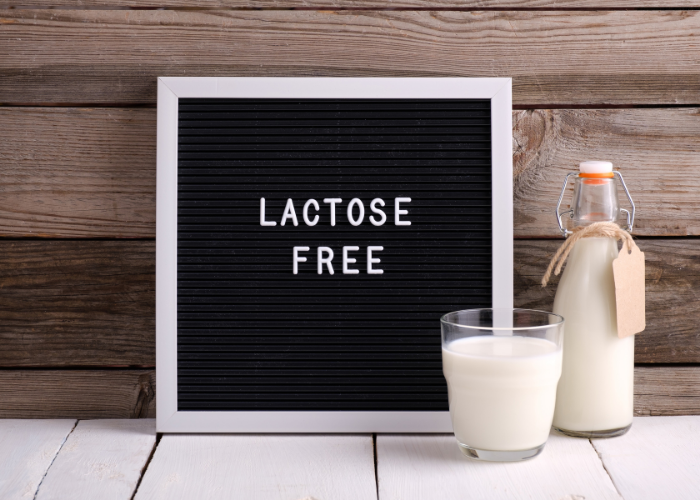 Lactose Free Sign next to a glass and a bottle of milk