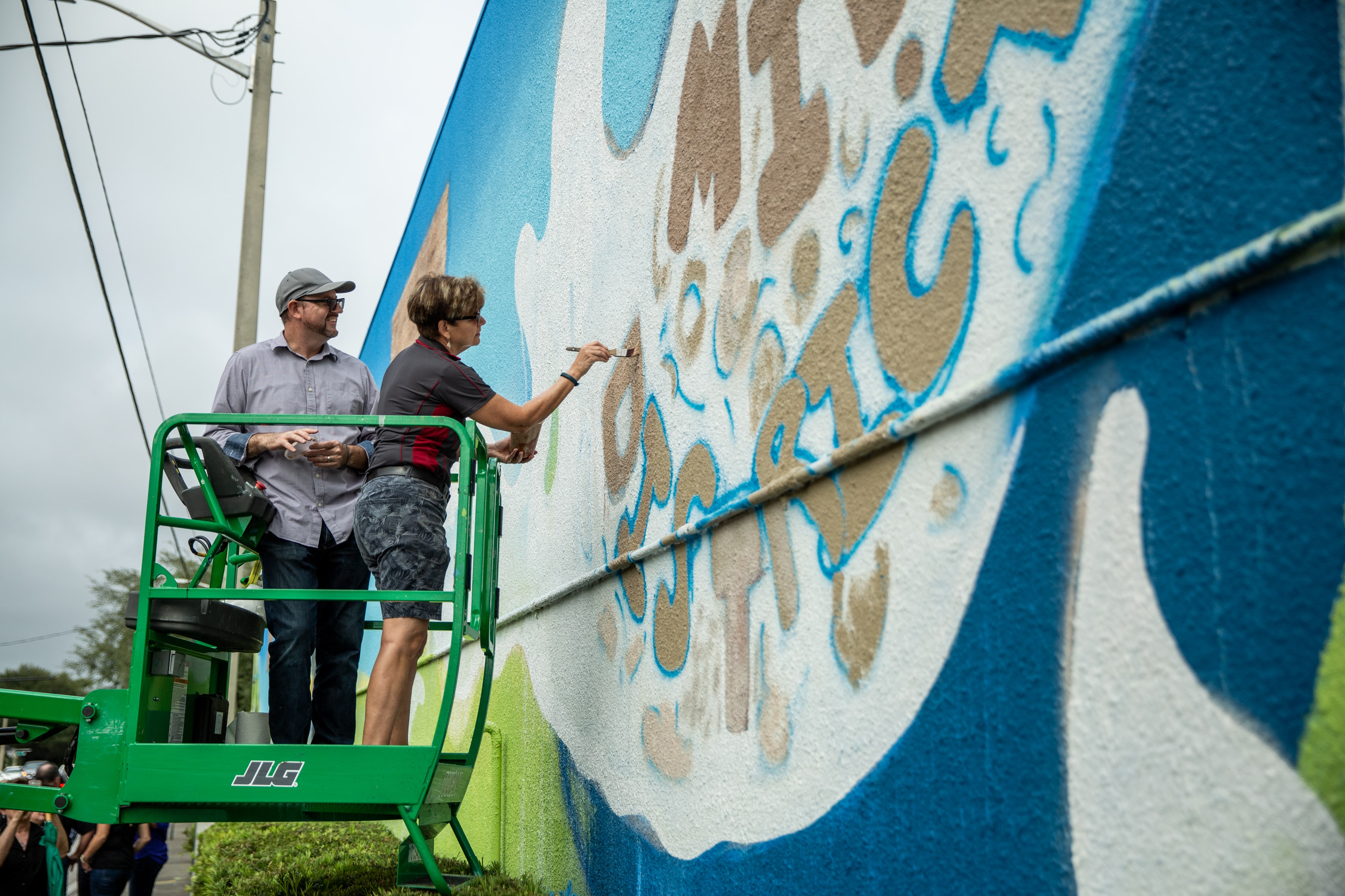 Public official working on mural 