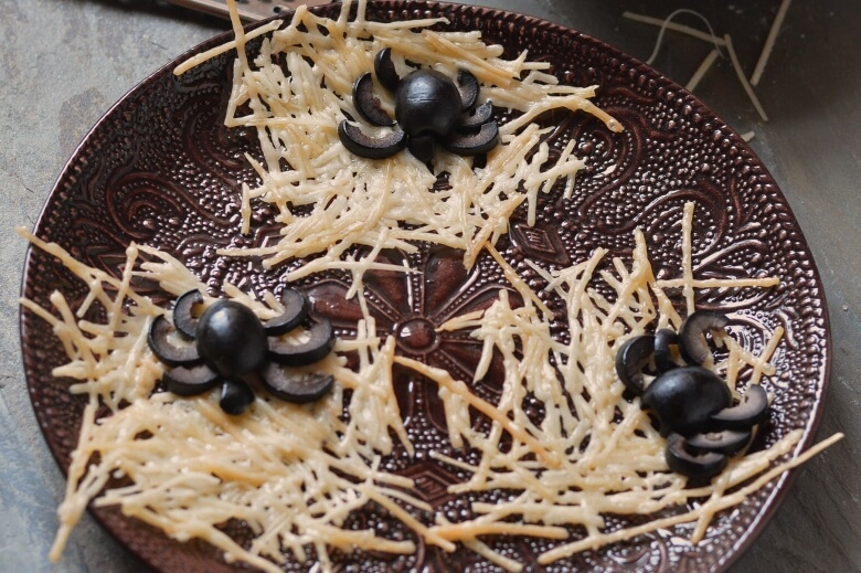 Parmesan Cheese Crisps with Black Olive Spiders
