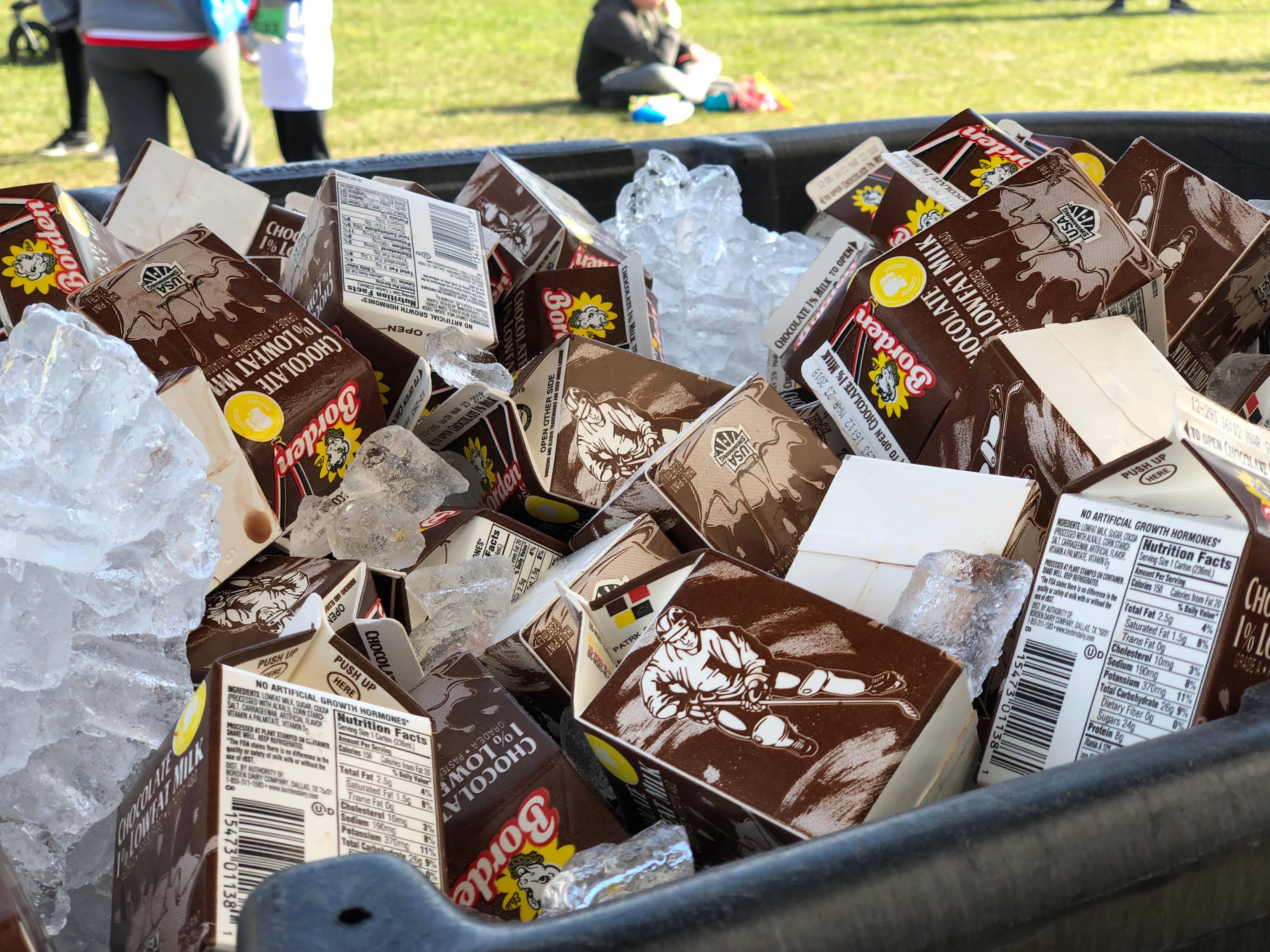 cartons of chocolate milk in an ice tub
