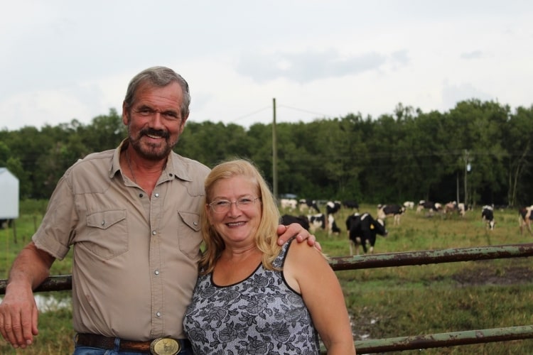 dairy farmer Klaas Reyneveld standing in field with his wife