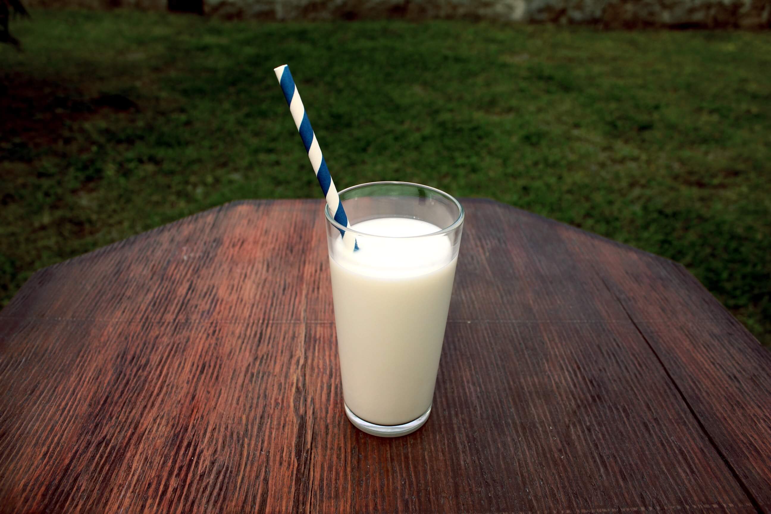 milk-in-a-glass-on-a-table-outdoors