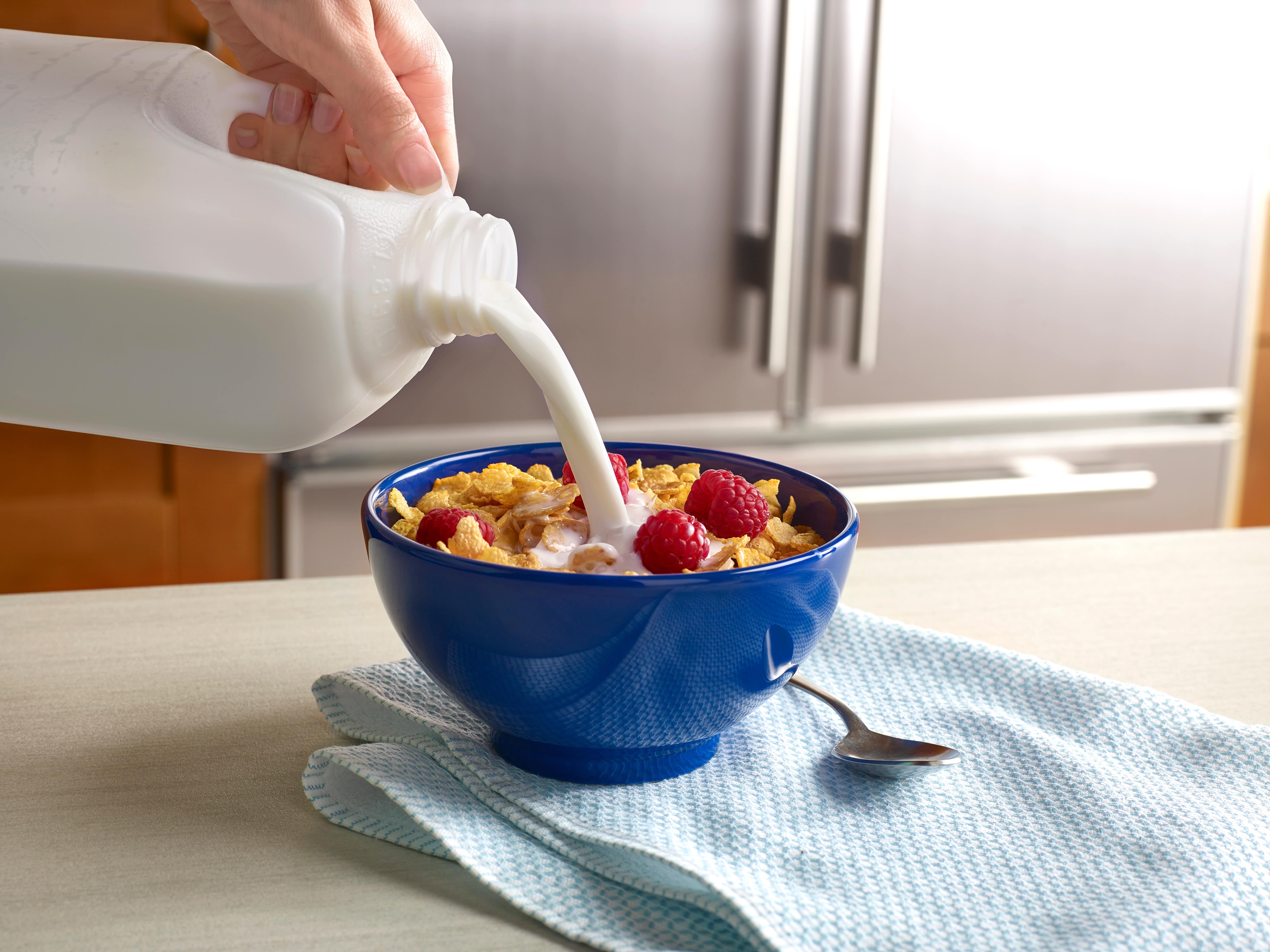 milk-pouring-into-ceral-bowl-min