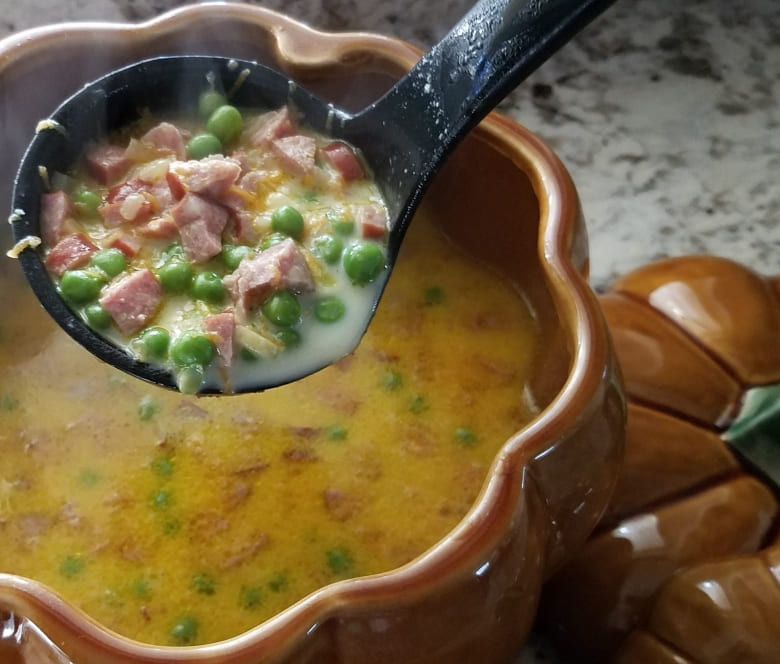 Creamy Cauldron of Carrots, Smokey Sausage, and Sweet Pea Soup Featured Image
